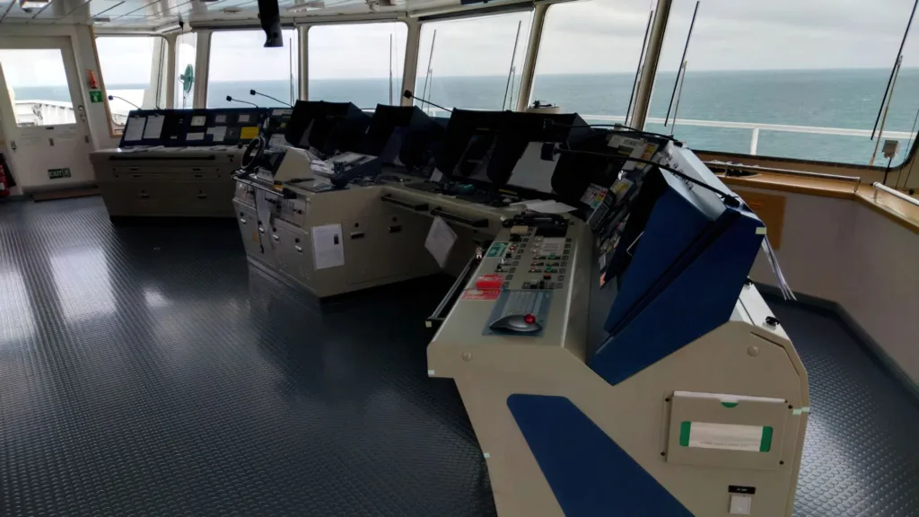 Bridge control room of a vessel, showcasing advanced navigation and communication systems used during Marine Surveying inspections for safety, compliance, and operational efficiency.
